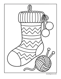 A knitted stocking with zigzag stripes, a ribbed cuff and two pom-poms, with a ball of yarn and knitting needles