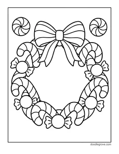 A wreath made of candy canes and wrapped candies with a big striped bow, with two peppermints
