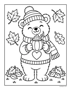 A bear in a striped hat, scarf and heart sweater holding a mug topped with whipped cream, between piles of leaves