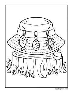 A bucket hat with fish, lure and feather charms on a tree stump, with a bobber and grass